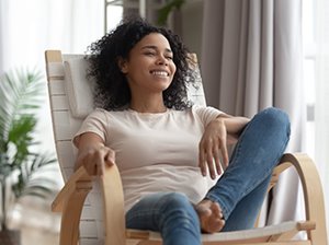 Woman relaxing in chair at home