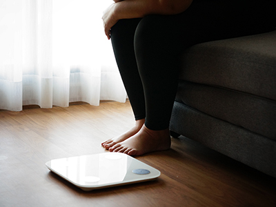 person sitting next to a scale