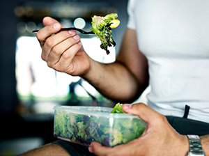 man eating salad