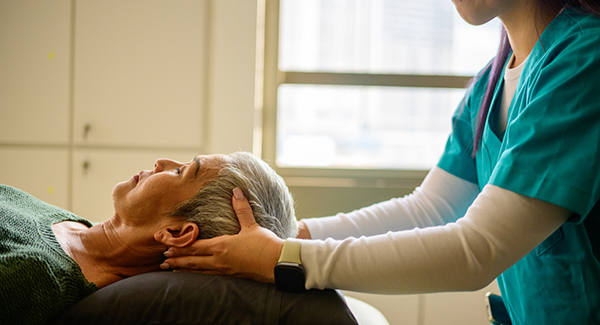 physician with patient moving neck