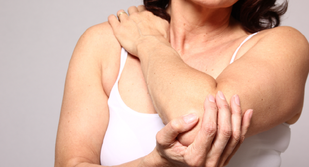 woman holding shoulder