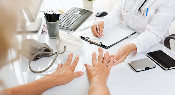doctor examining a womans hands