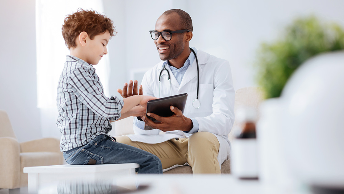 boy with JA talking to his doctor