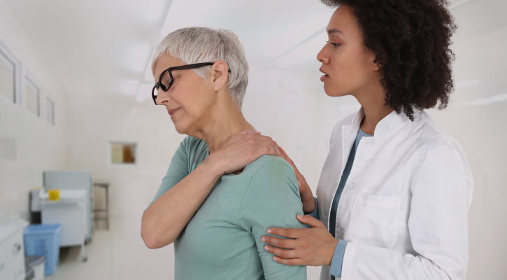 Woman holding shoulder