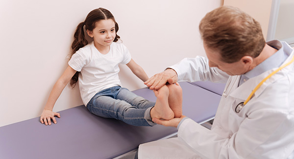doctor examining a little girl