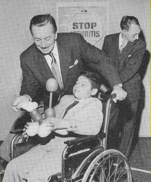 Walt Disney and a child in a wheelchair